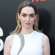 Actor Jamie Clayton poses in a white sleeveless outfit at a Sense8 red carpet event.